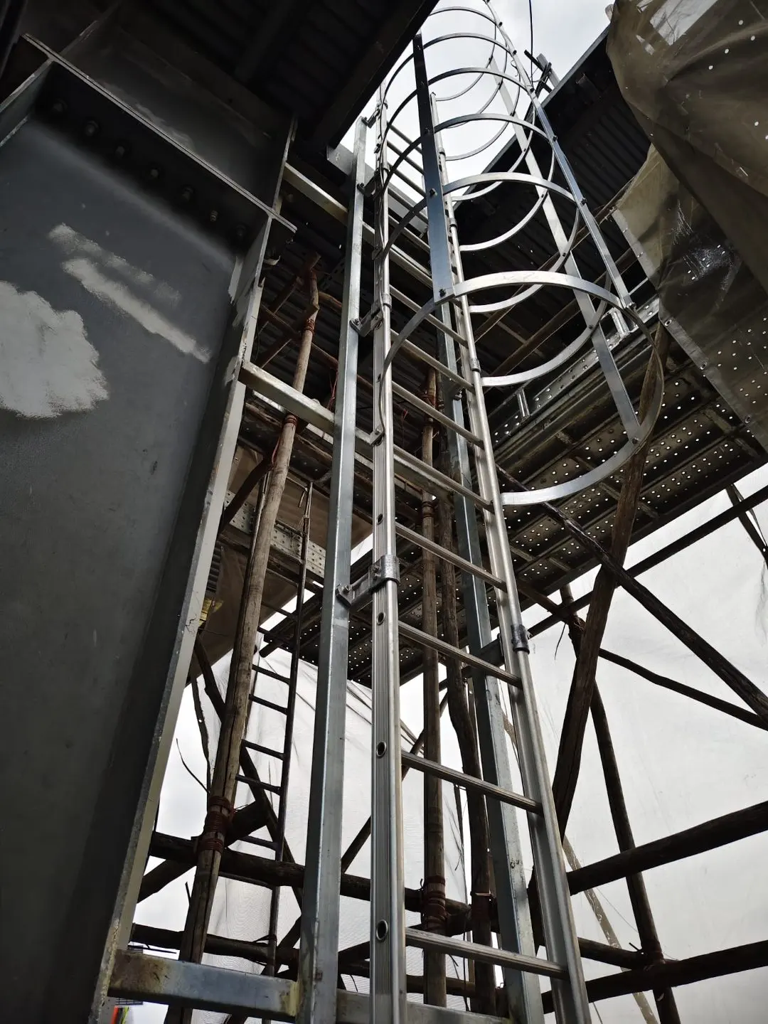 Ancillary building cat ladder add-on at Buroh Street — fixed vertical access ladder mounted on the smaller building wall