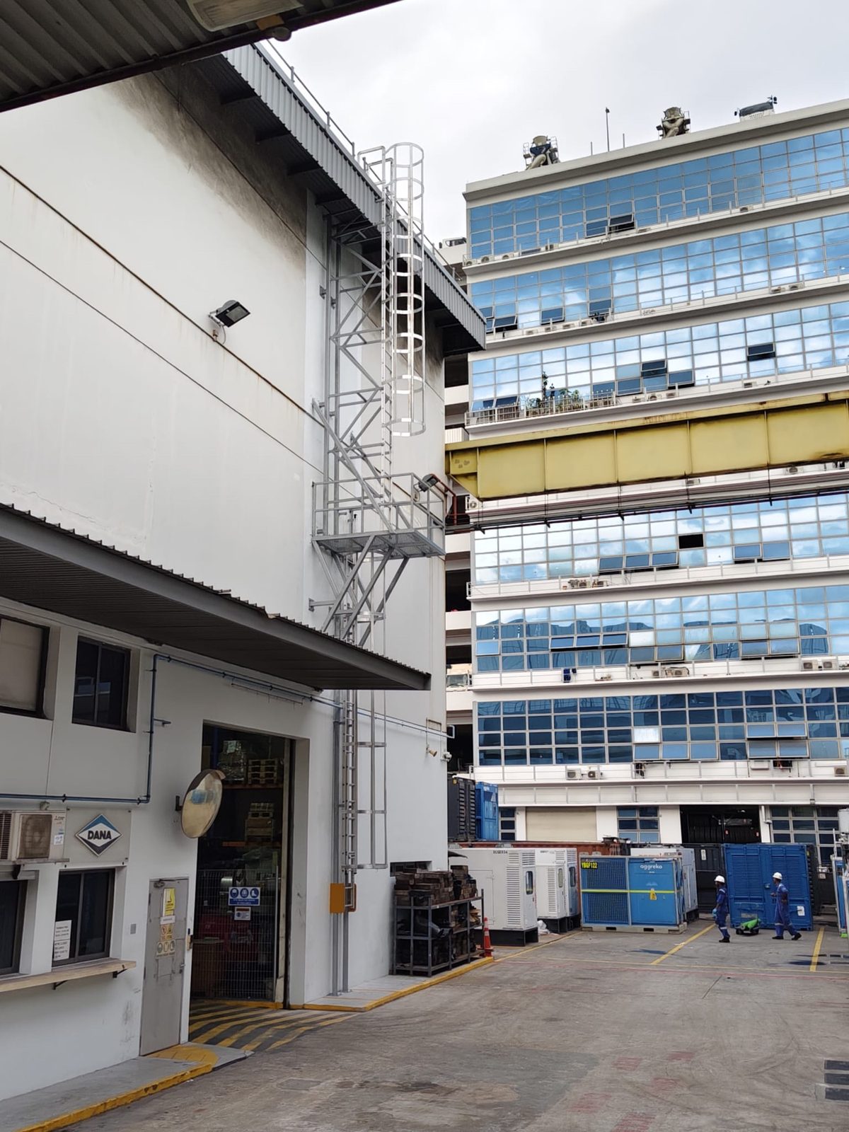 Side context view of the Buroh Street cat ladder with the mid-platform and supporting brackets, photographed from the loading yard