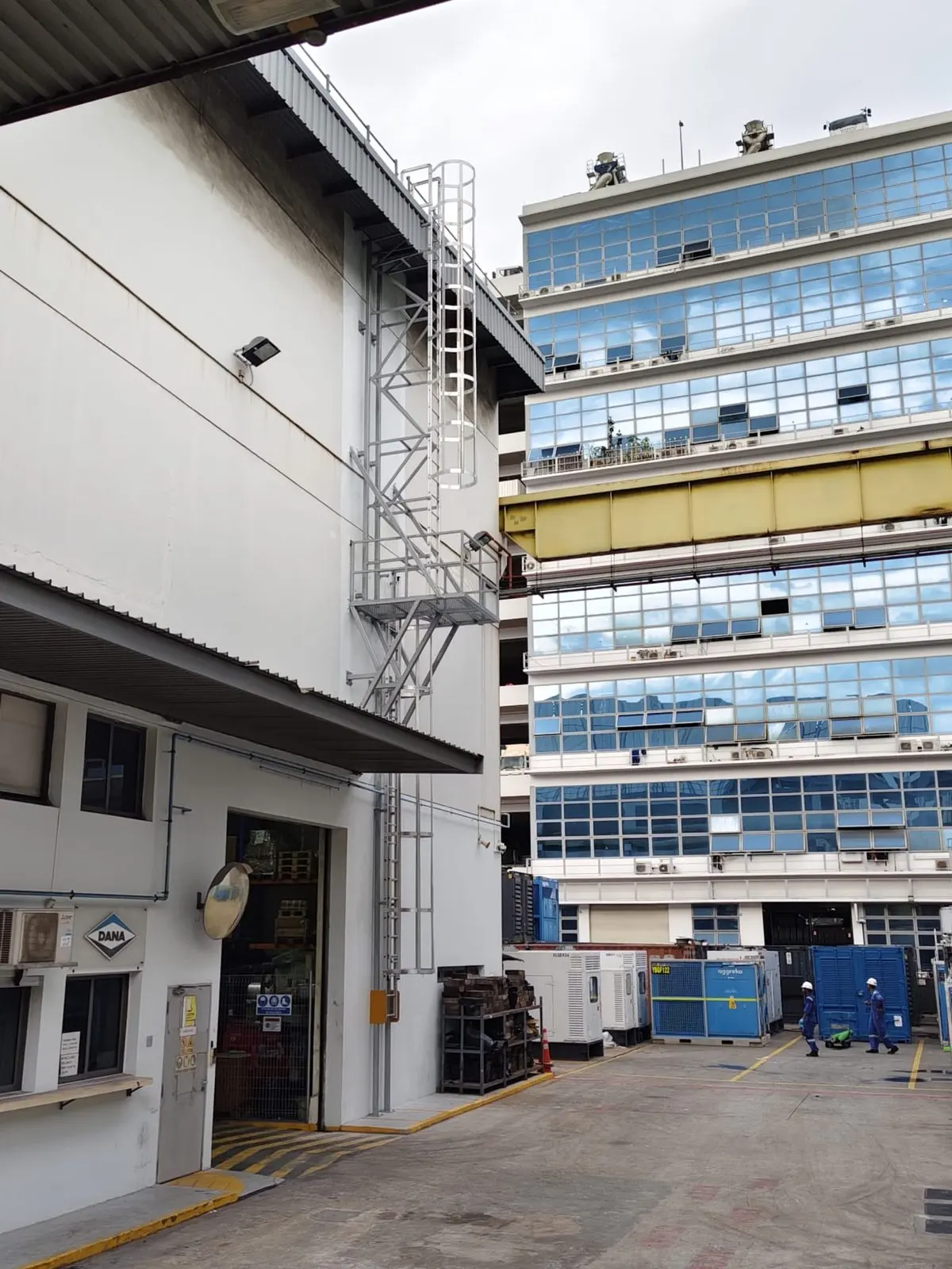 Side context view of the Buroh Street cat ladder with the mid-platform and supporting brackets, photographed from the loading yard
