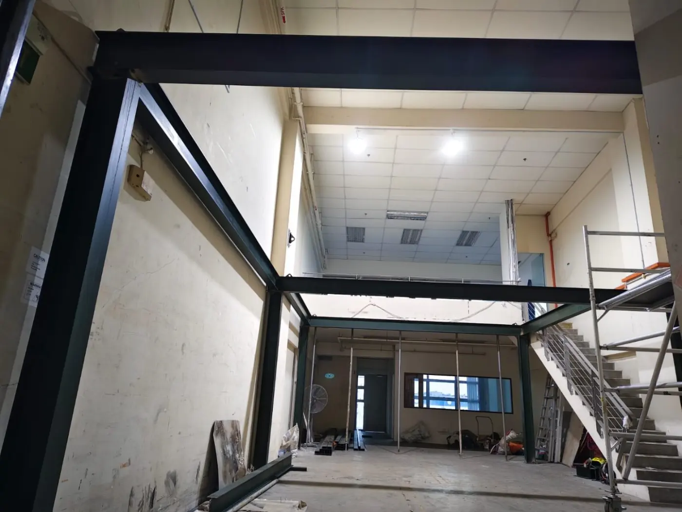 Completed mezzanine steel frame at Frontier Industrial Building viewed from the lower floor with the elevated platform set against the existing wall