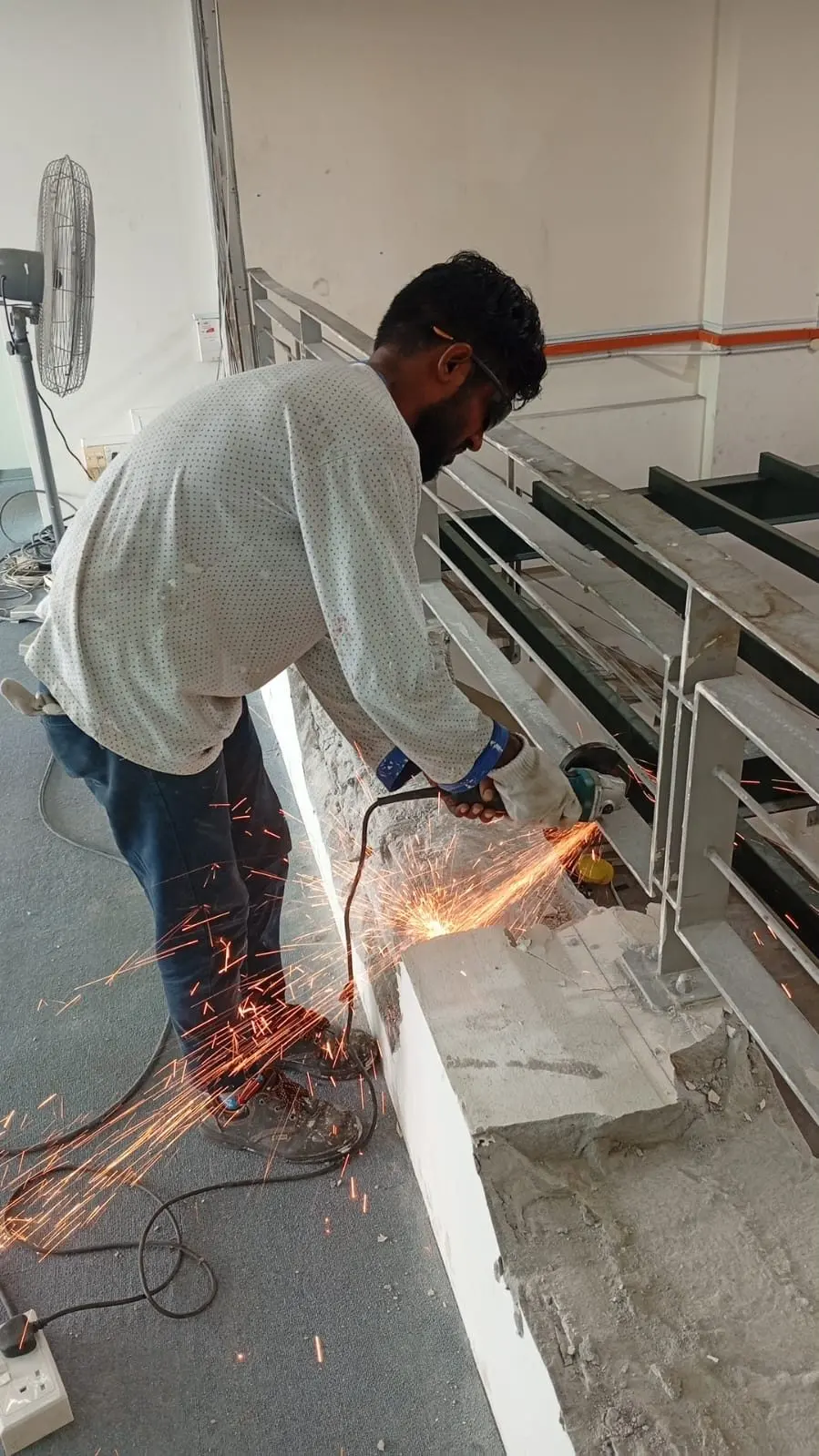 Welder fabricating mezzanine steel members at Frontier Industrial Building