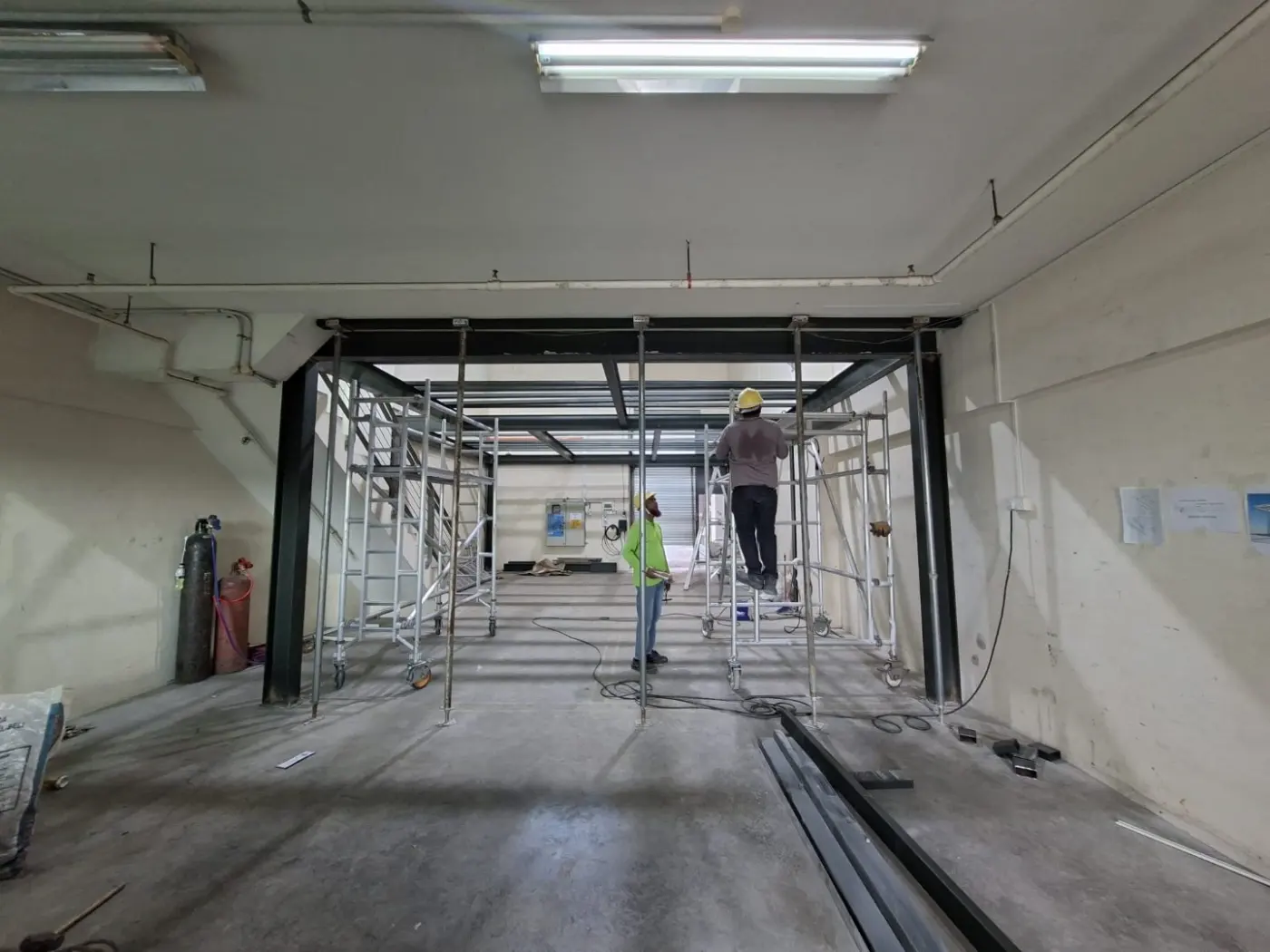Long view down the Frontier Industrial Building unit showing the mezzanine framing aligned along the side wall during installation