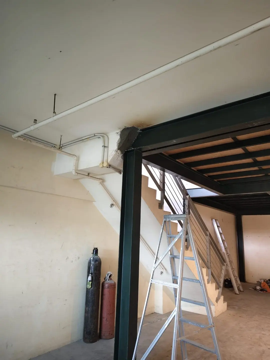 Edge of the mezzanine opening at Frontier Industrial Building showing the steel frame against the existing wall