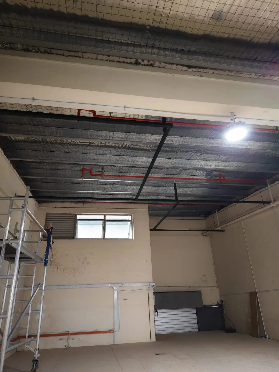 Wide internal view of the Frontier Industrial Building unit showing the mezzanine steel frame in place along the side wall