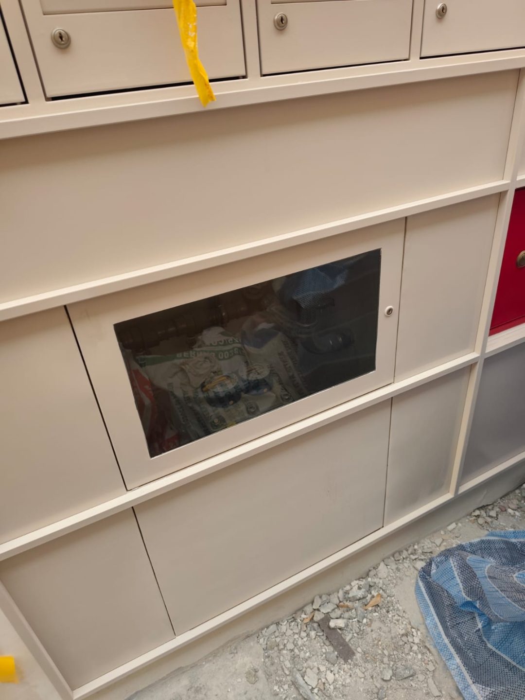 Angled view of the Jalan Penhas mailbox bank showing the slot row, framing trim and stainless steel door alignment