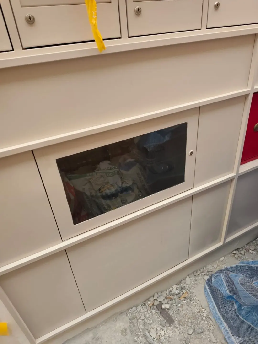 Angled view of the Jalan Penhas mailbox bank showing the slot row, framing trim and stainless steel door alignment