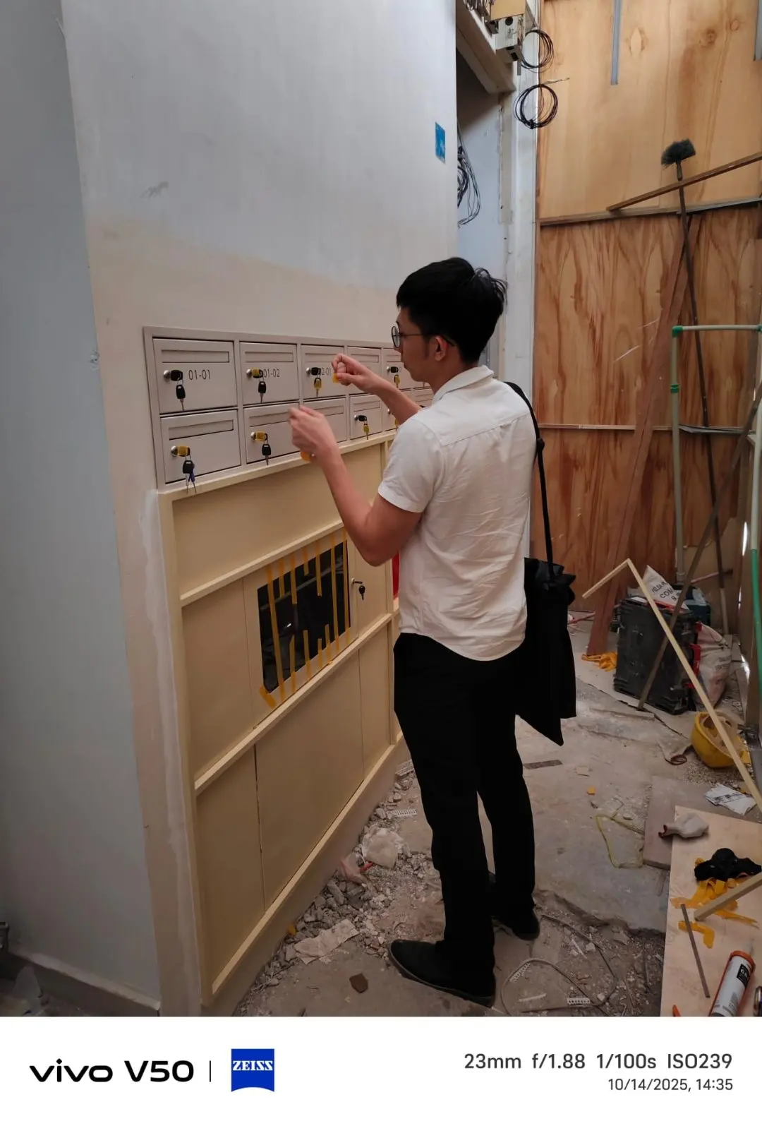 Resident operating an opened SS304 mailbox door at the Jalan Penhas installation