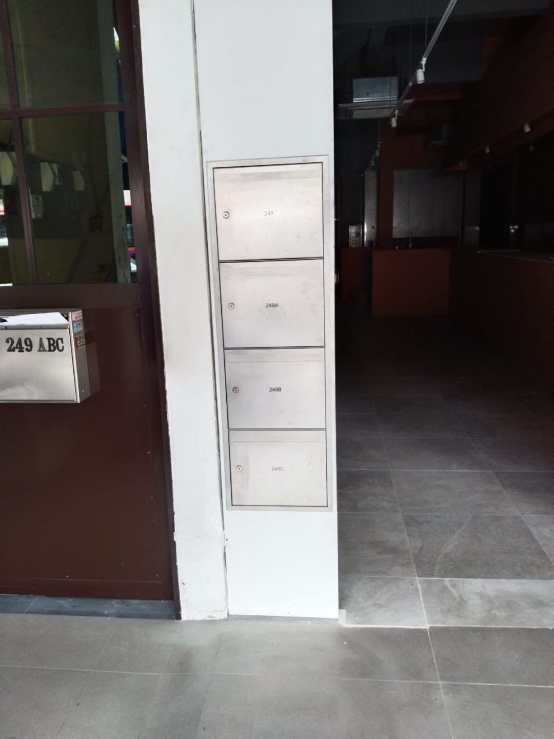Wider front view of the Outram Road entrance area with the SS304 stainless steel mailbox unit in place