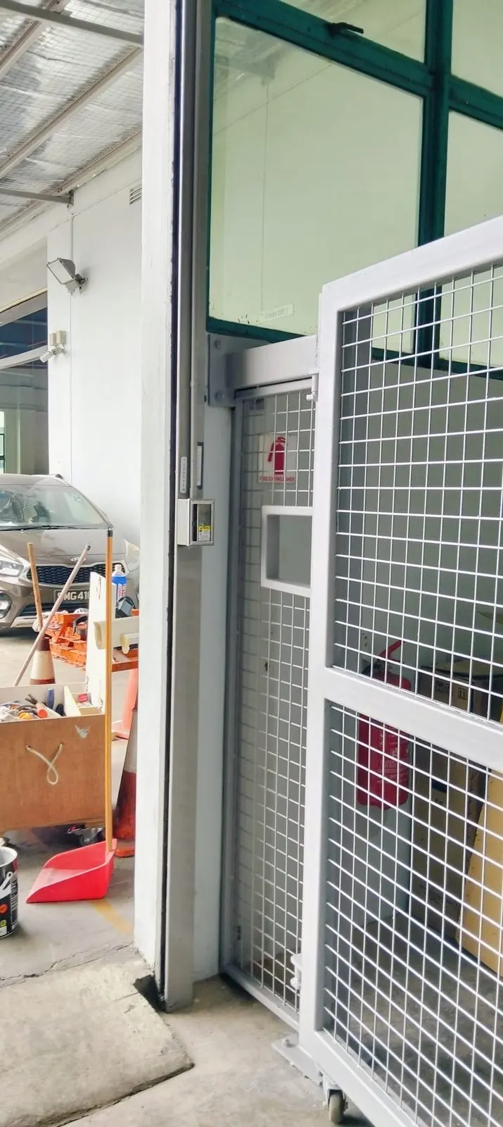 Open metal gate at Strides Premier showing the welded mesh panel and steel frame detail at the leaf edge