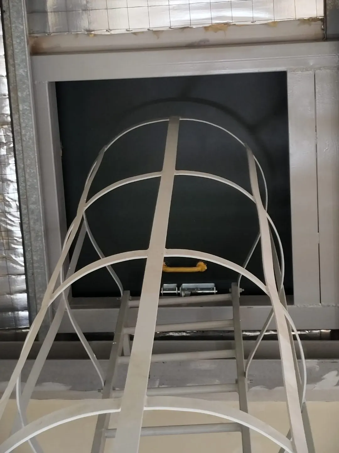 Looking up through the roof access opening at Wan Lee showing the cat ladder hoop cage above the hatch