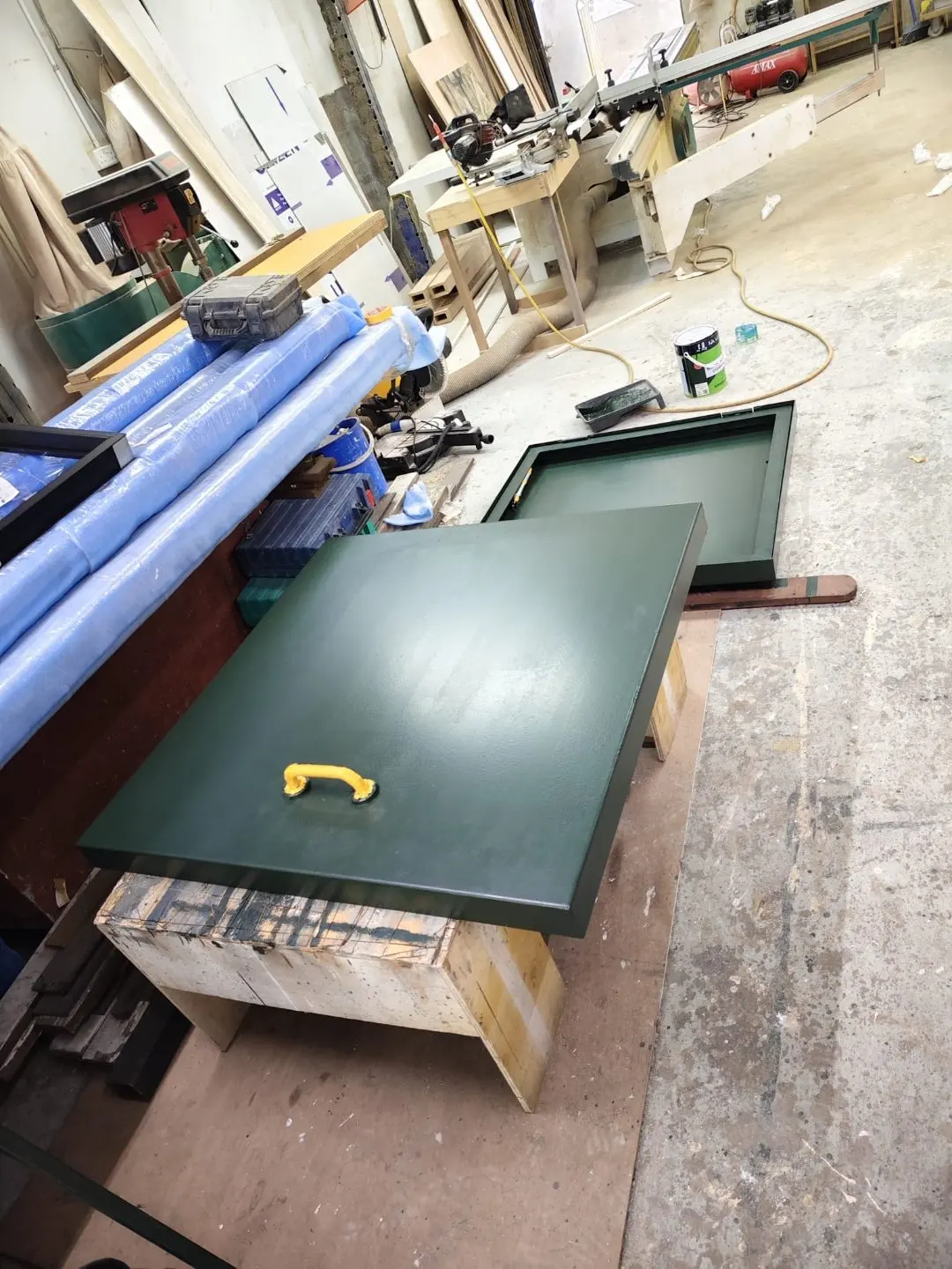 Roof access hatch panel laid out on workbench during fabrication for the Wan Lee project